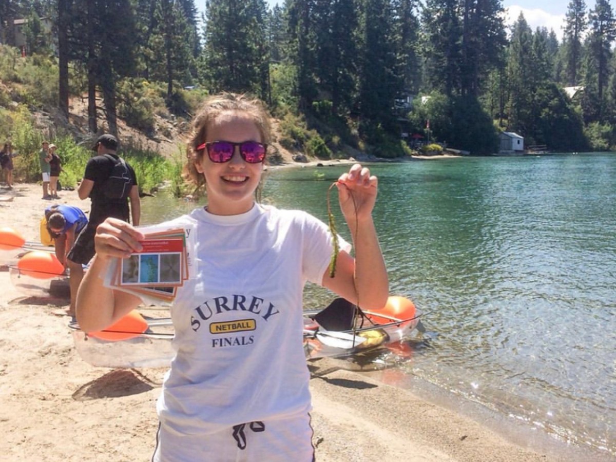 a person standing next to a lake