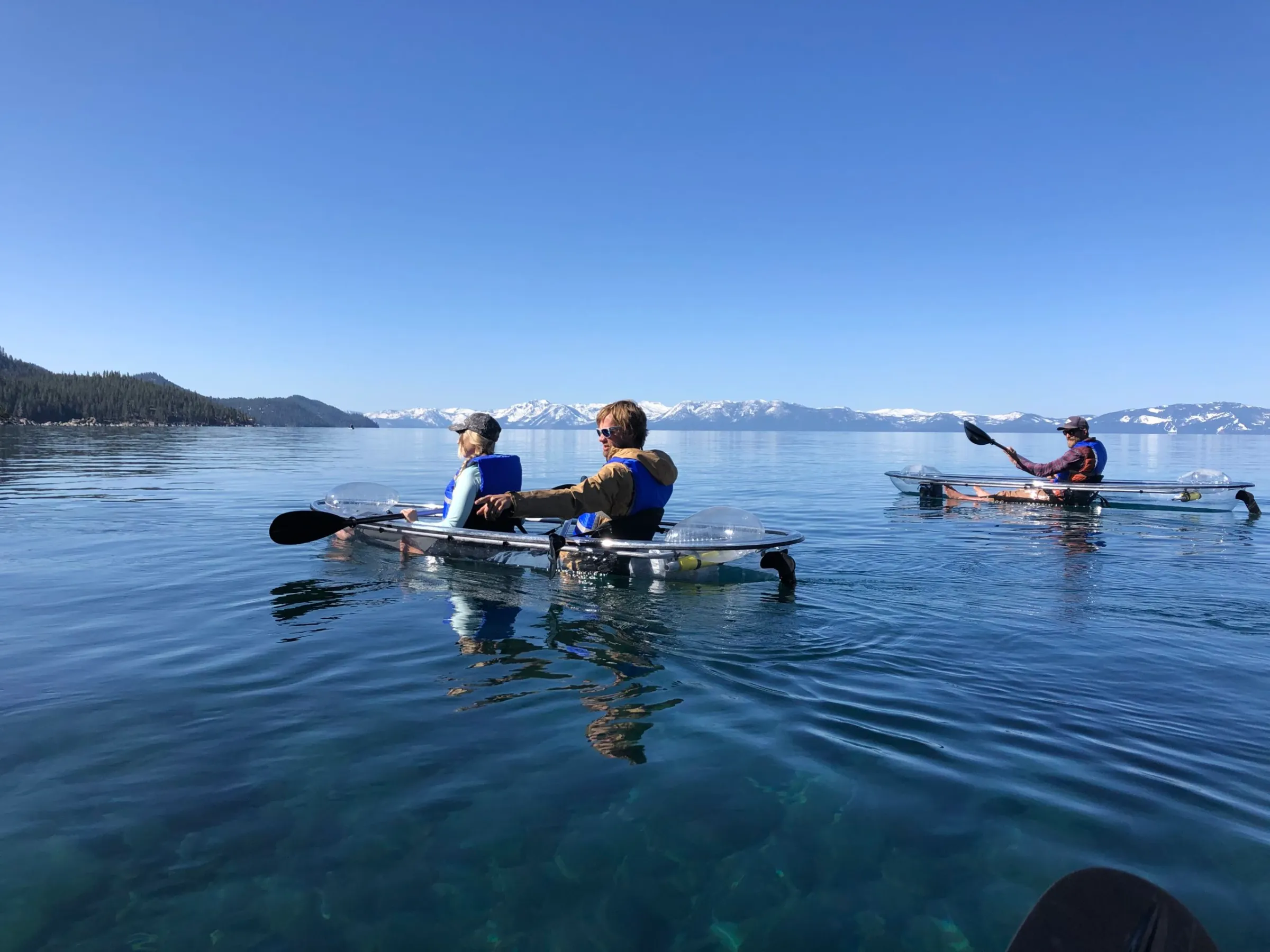 a group of people rowing a boat in the water