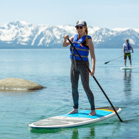 a man standing next to a body of water