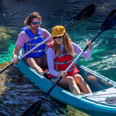 a person riding on the back of a boat in the water