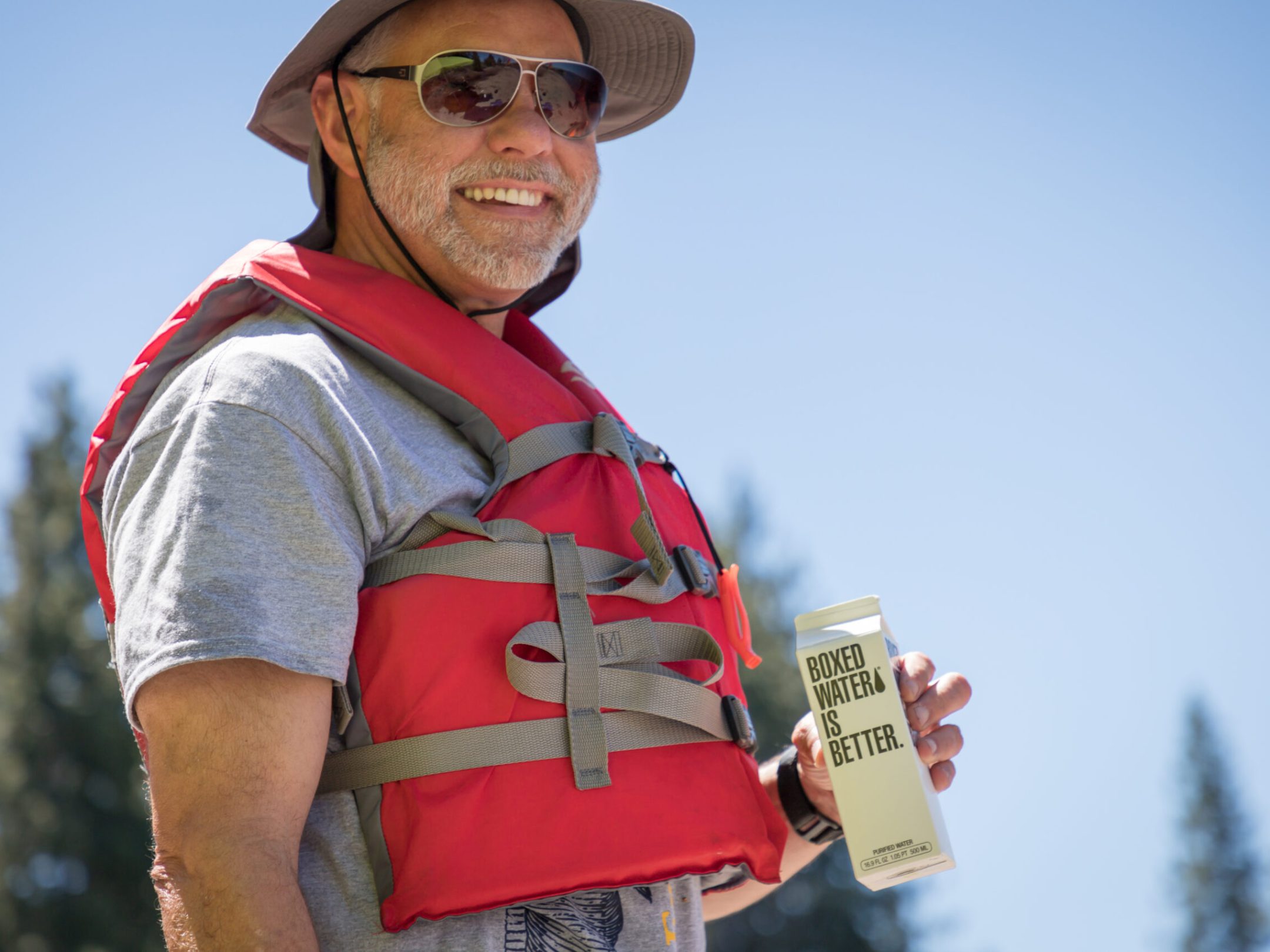 a man wearing a hat and sunglasses