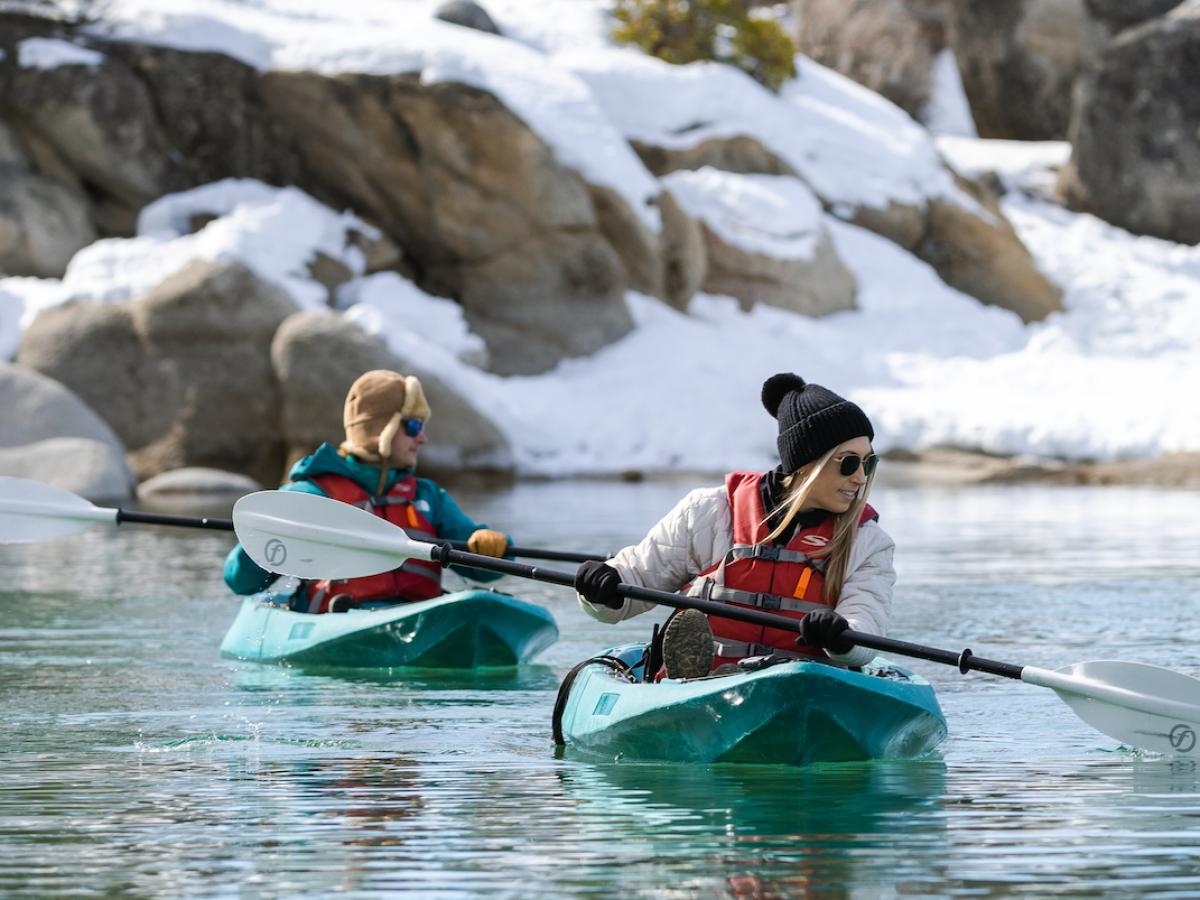 a man riding a snow board in the water