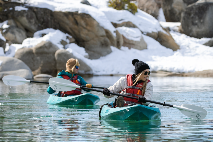a man riding a snow board in the water