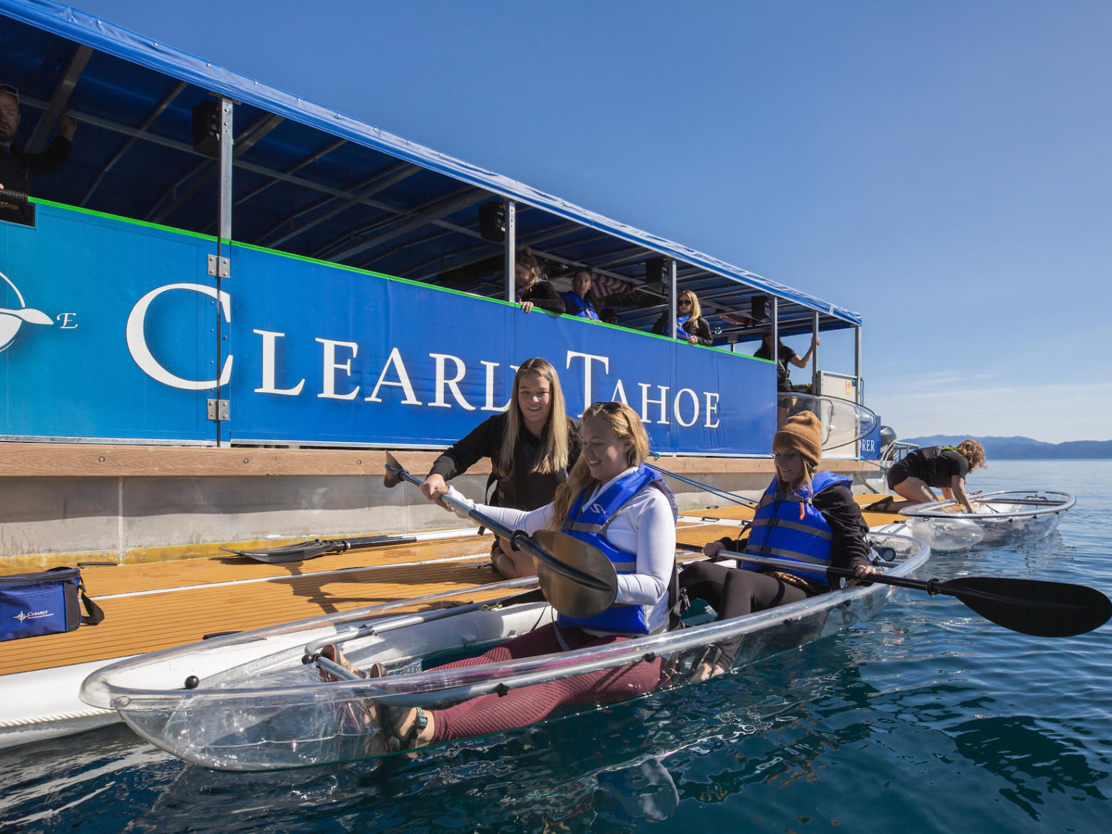 a group of people riding on the back of a boat