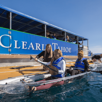 a group of people riding on the back of a boat