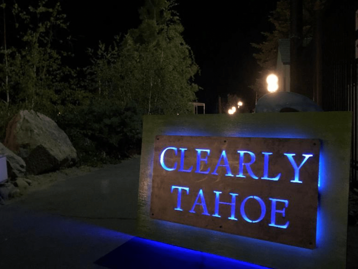 a sign lit up at night