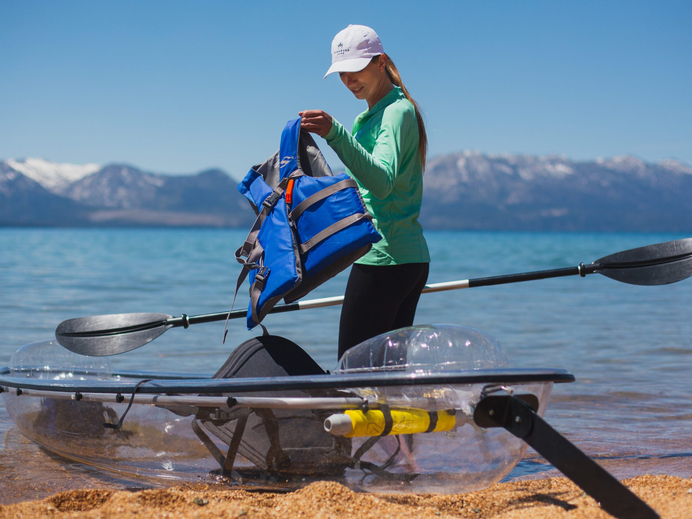 a man standing next to a body of water
