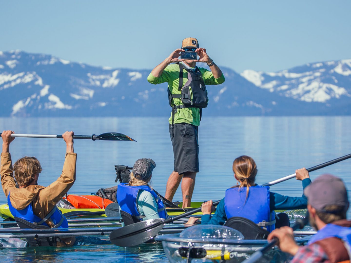 a group of people rowing a boat in the water