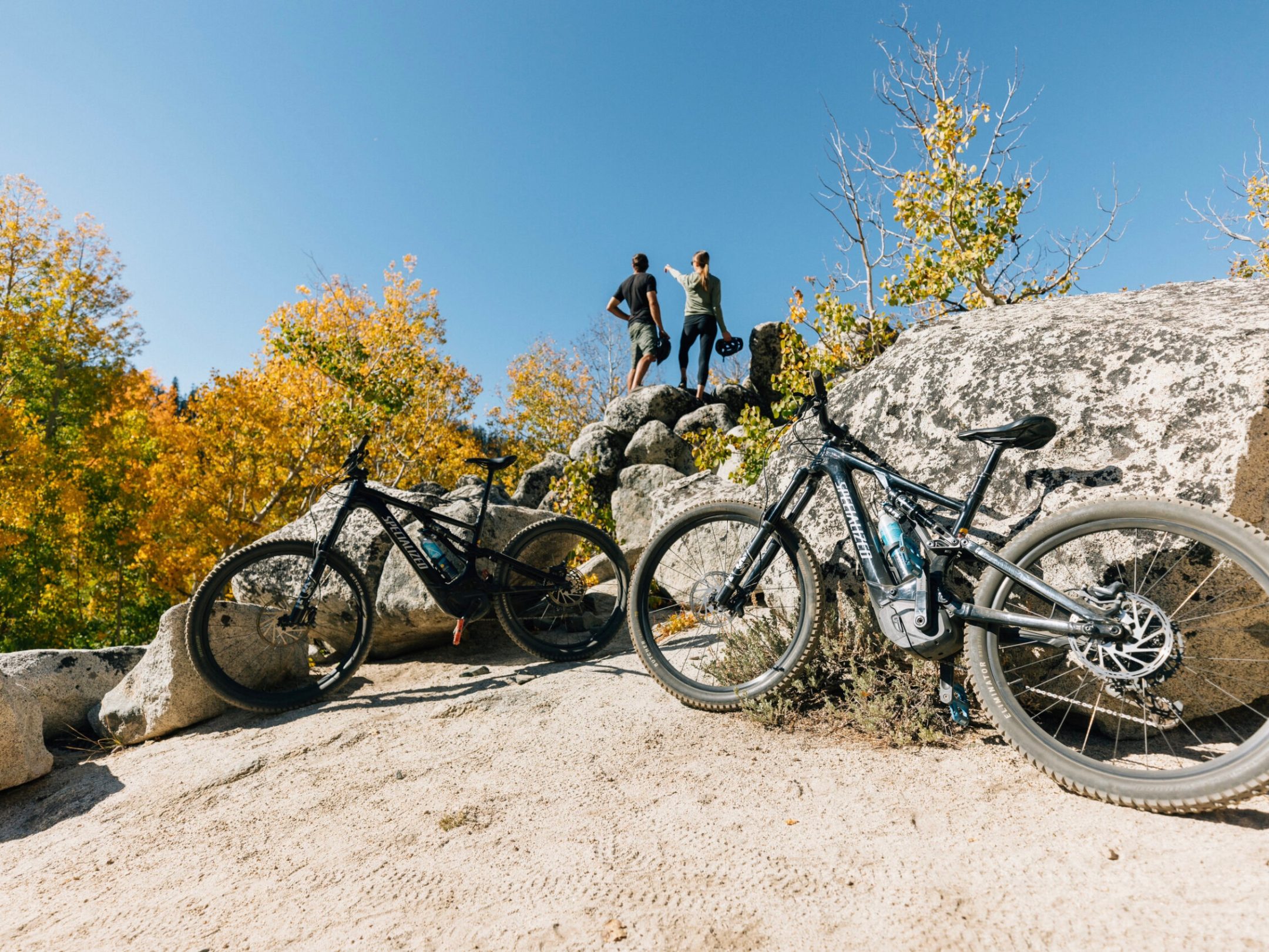 a bicycle parked on the side of a rock
