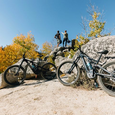 a bicycle parked on the side of a rock