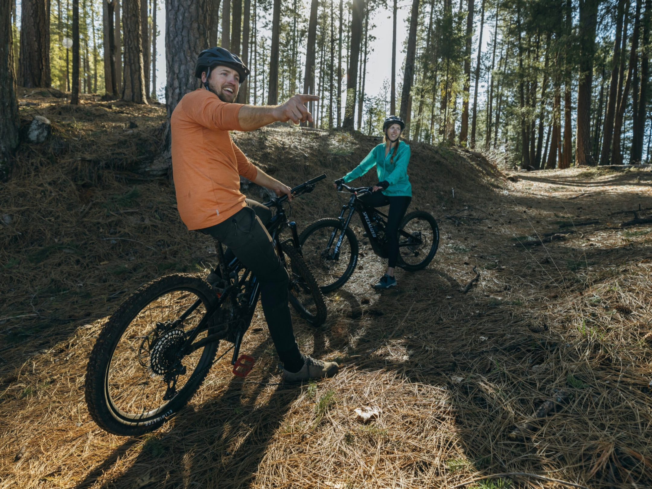 a man riding a bike down a dirt road