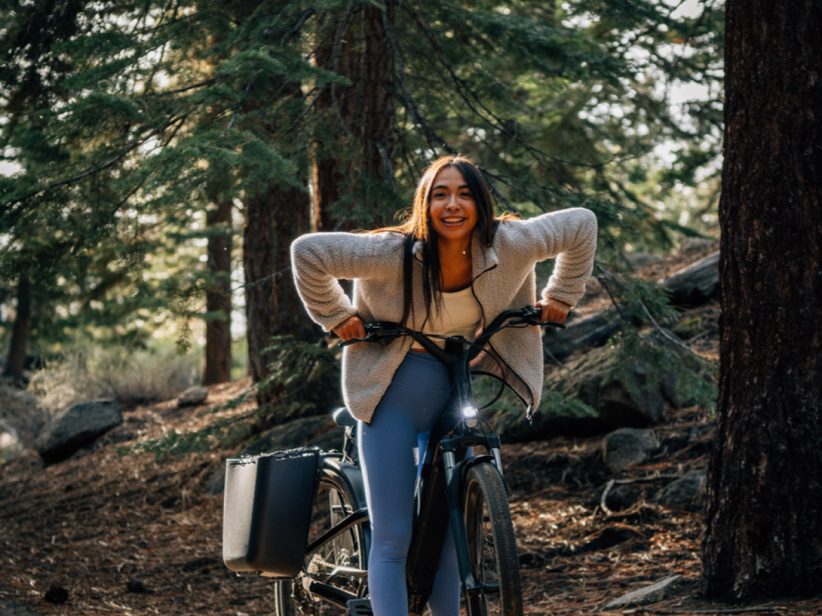 Lindsay DeLuca riding a dirt bike in the forest