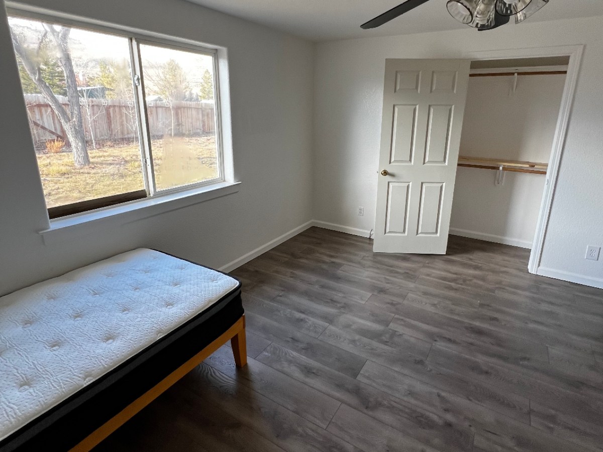 a room filled with furniture and a large window