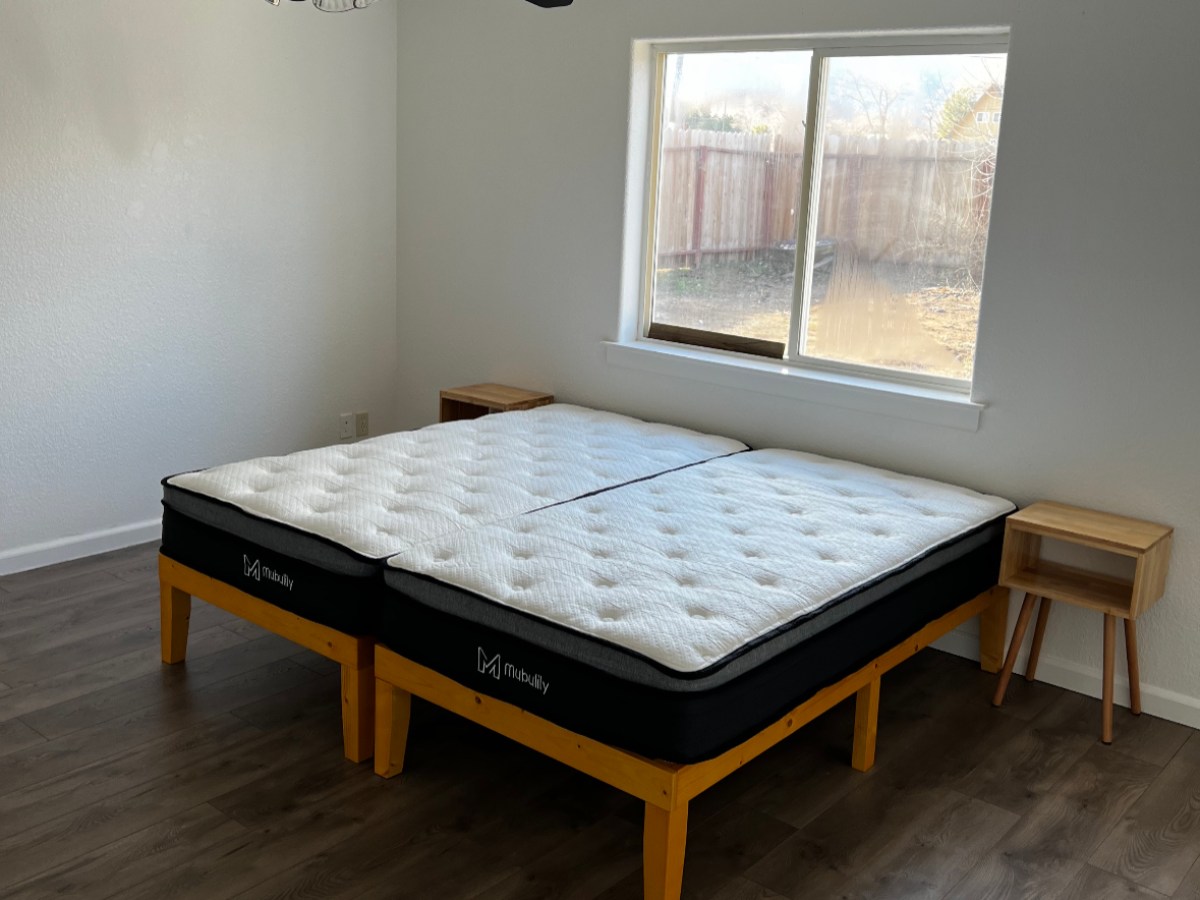 a bedroom with a wood floor