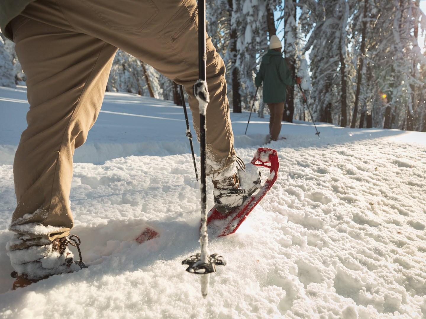 a man standing on top of a snow covered slope