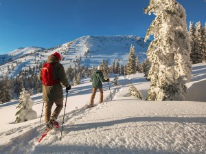a group of people standing on top of a snow covered slope