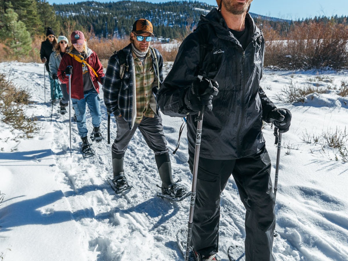 a couple of people that are standing in the snow