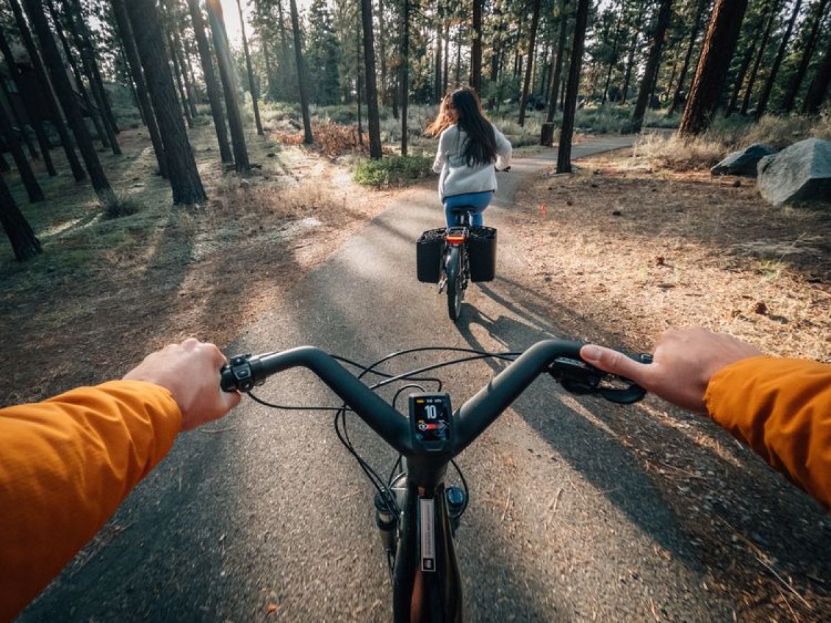 a person riding on the back of a bicycle