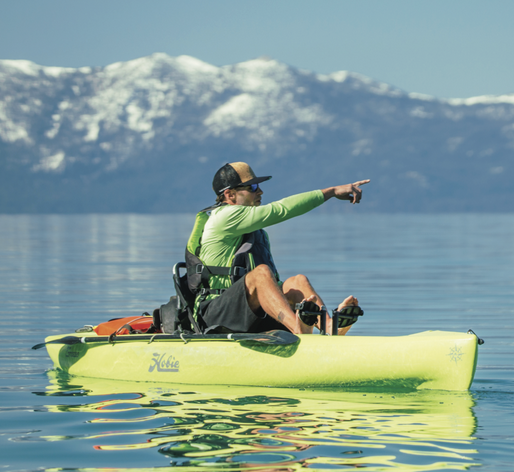 a person riding on the back of a boat in a body of water