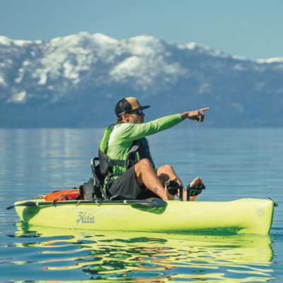 a person riding on the back of a boat in a body of water